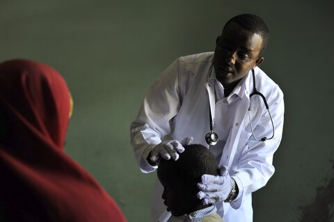 Photo: Doctor treating child
