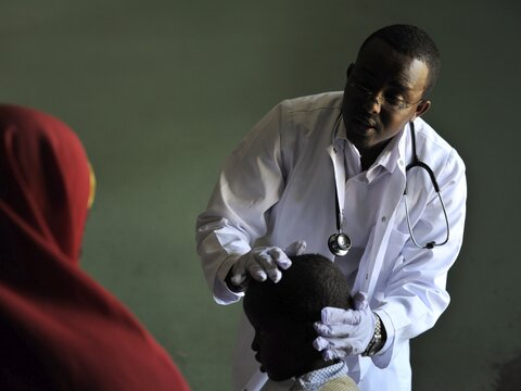 Photo: health worker with mother and child
